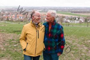 senior gay couple portrait, rural background