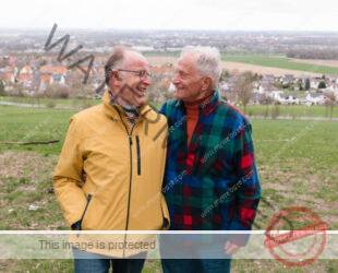 senior gay couple portrait, rural background